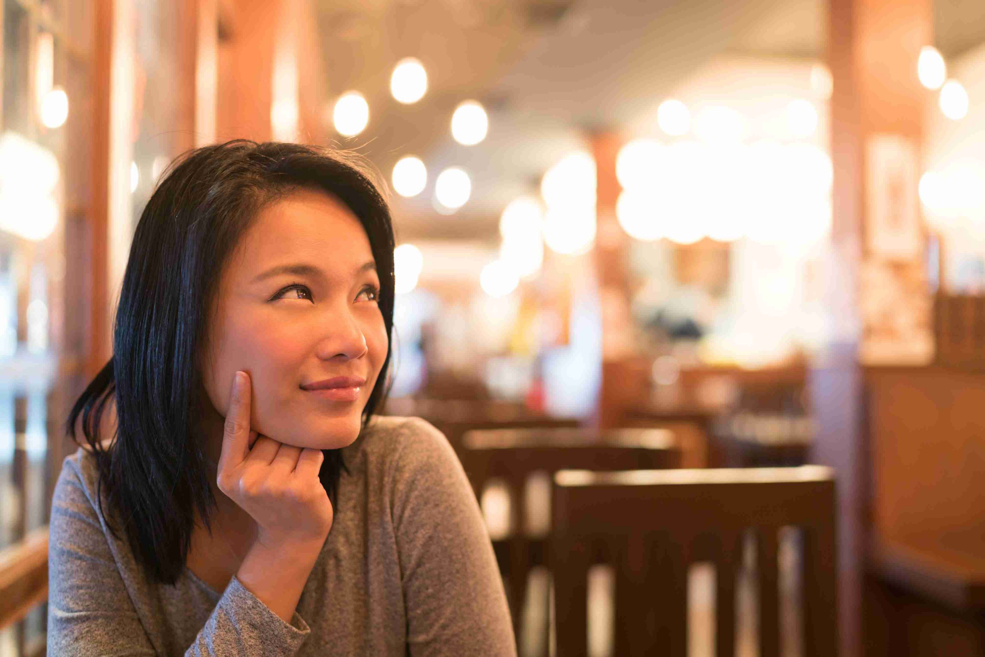 A woman in a restaurant looking up