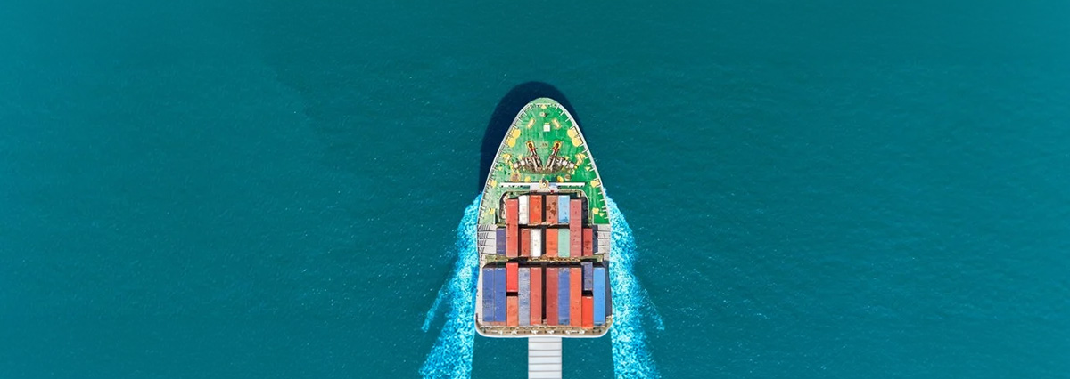 The bow of a cargo ship is breaking through the sea