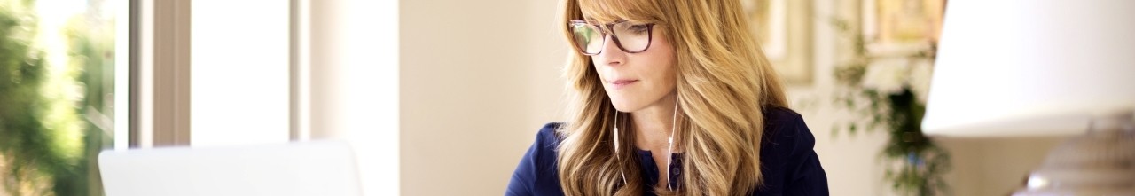 a woman wearing glasses and earphones