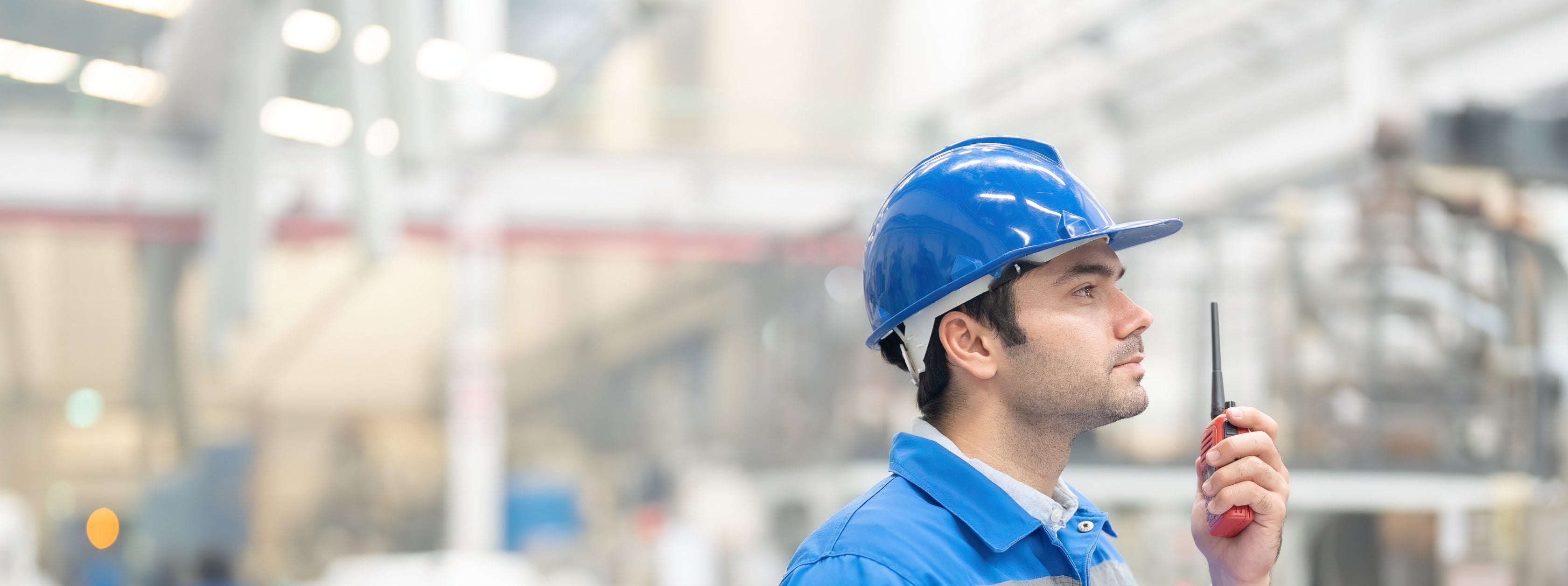 man in factory using radio device