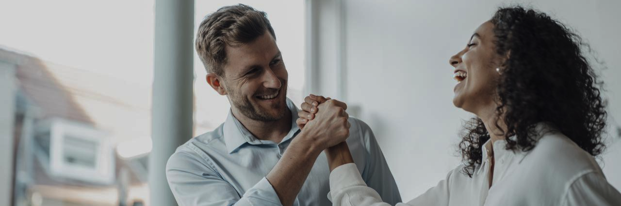 people shaking hands and laughing