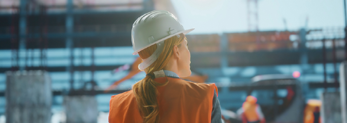 infrastructure projects woman worker standing back to the camera