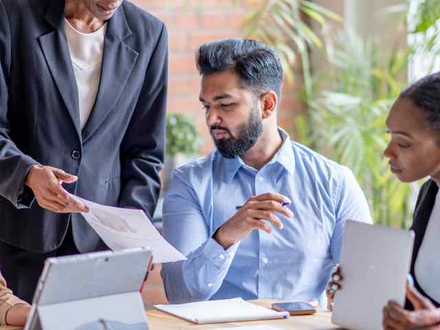 Colleagues analyzing documents during a meeting