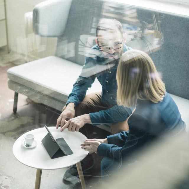 People discussing on a coach