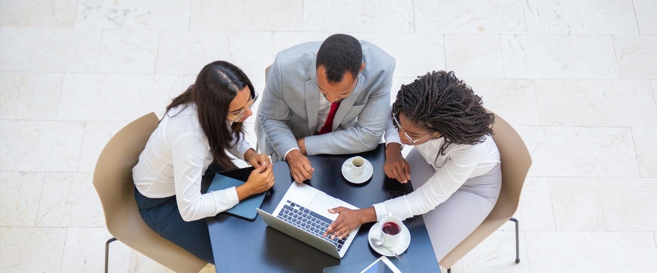 Diverse team working on project during coffee break