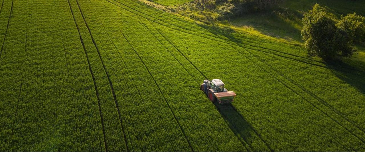 tractor driving through a field