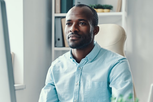 man in front of the desktop in the office