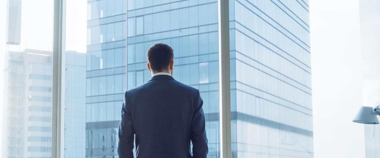 man looking out of window