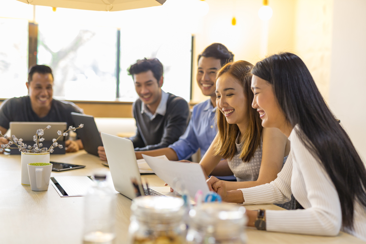a group of people discussing in a meeting room