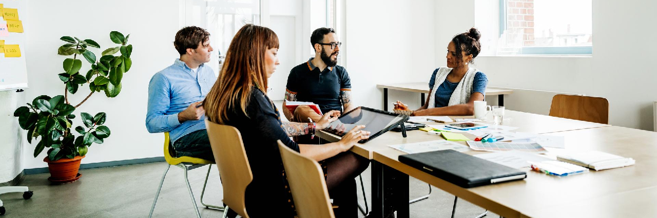 four-people-meeting-in-office-hero