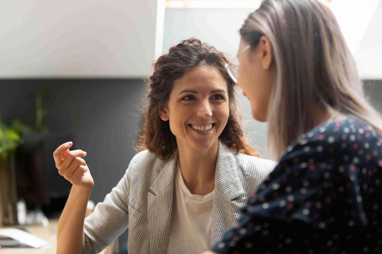 two ladies chatting cheerfully 