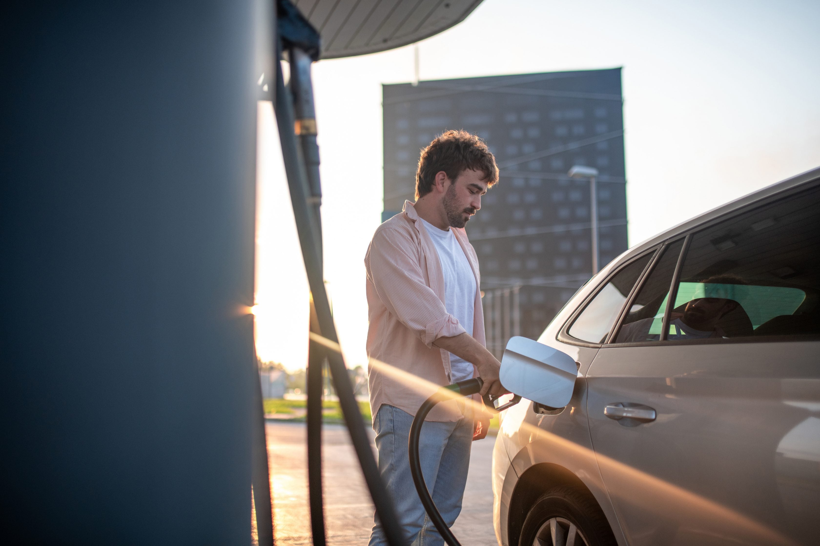 man pumping gas at station