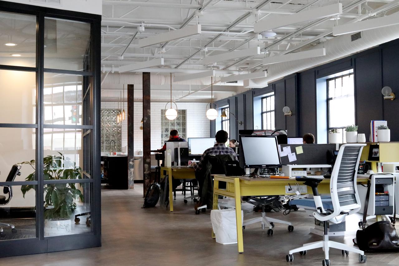 office setting with multiple employees working at computers