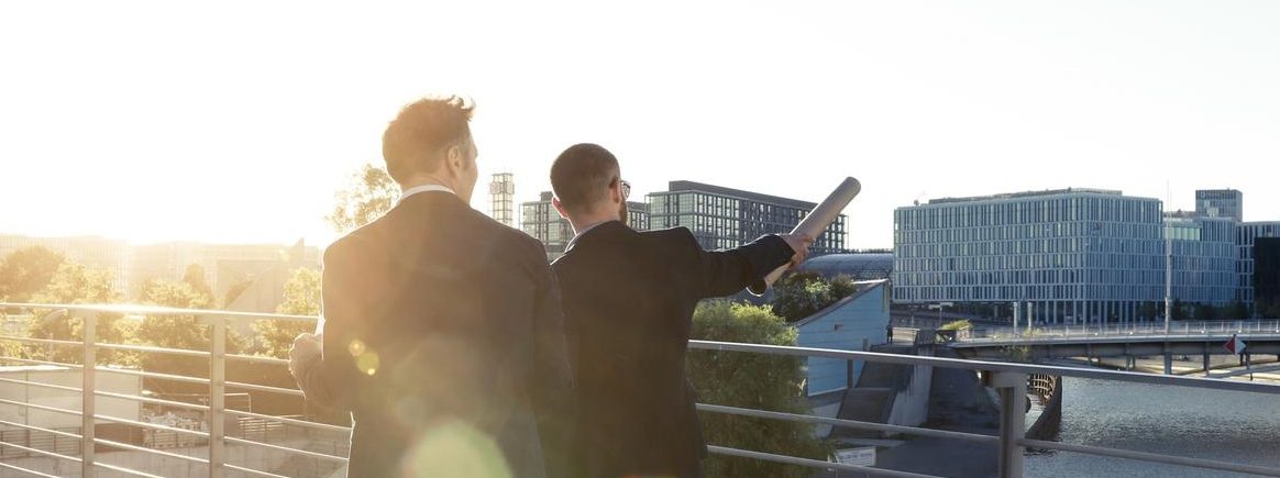 two men looking out at lake