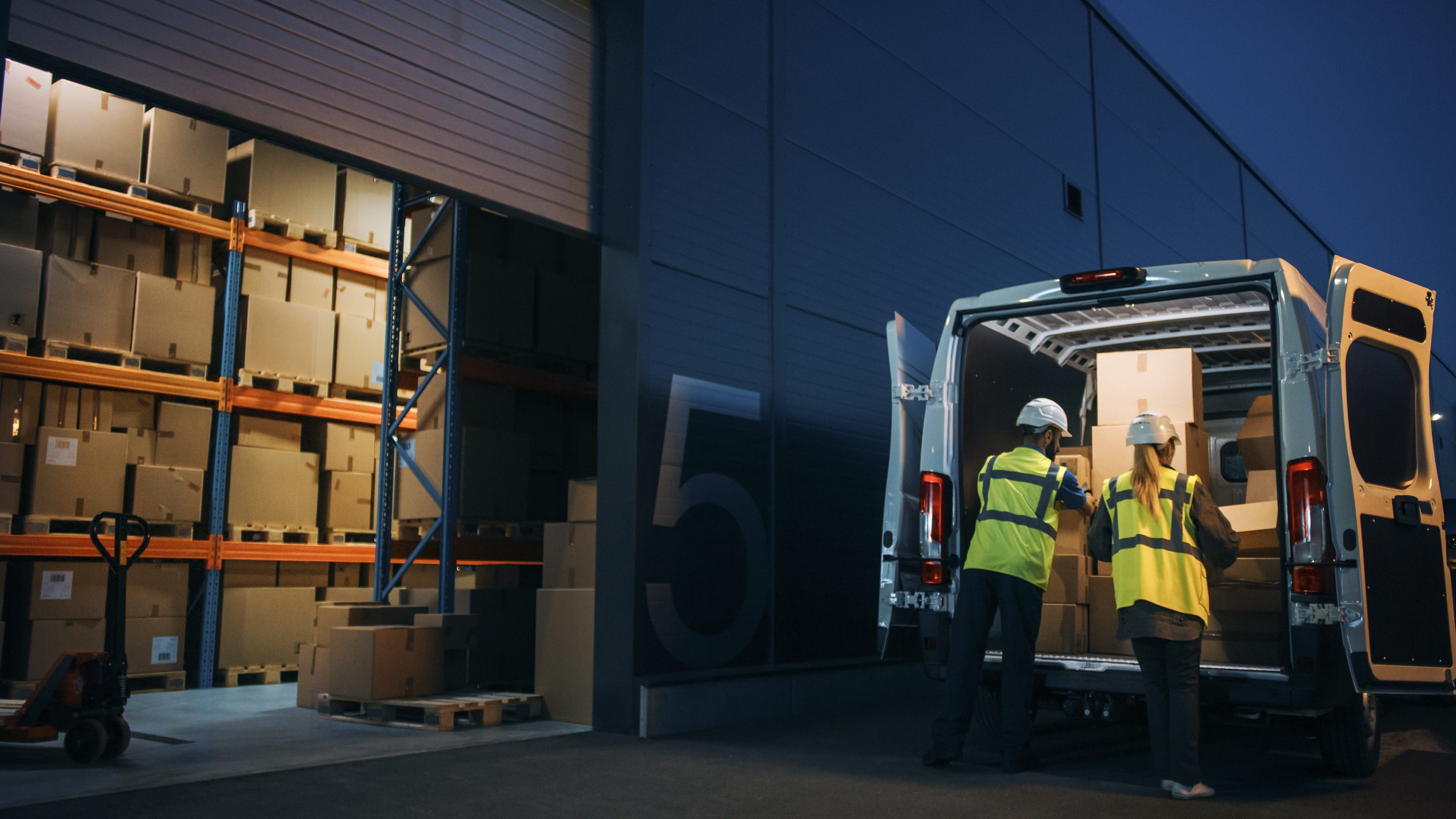 two workers loading a van