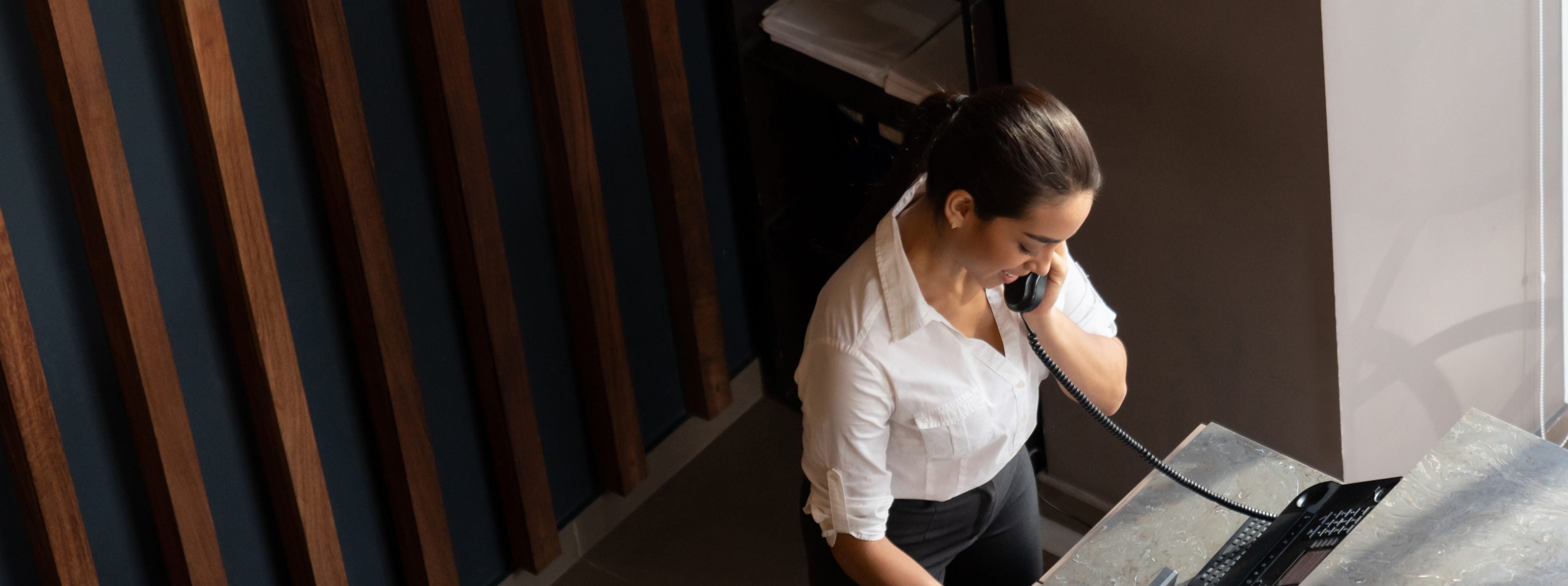 woman in office on phone and computer