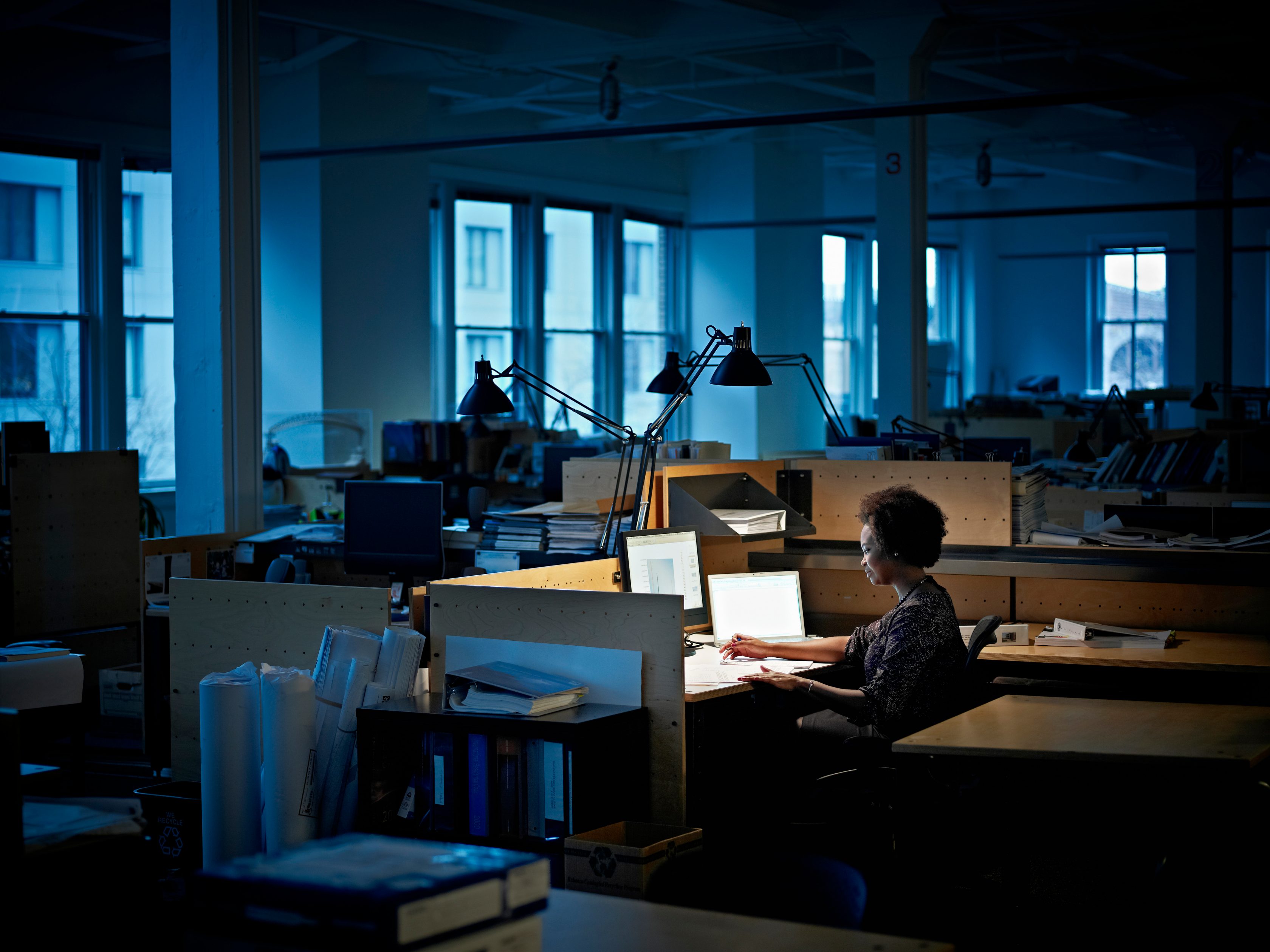 three workers talking in warehouse