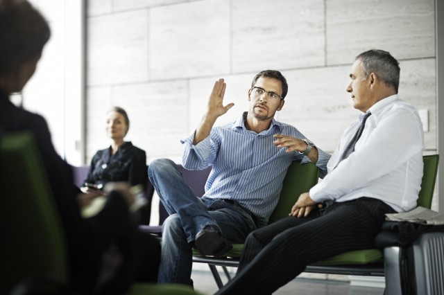 co-workers talking in office setting