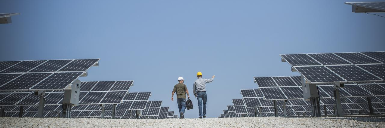 men with solar panels