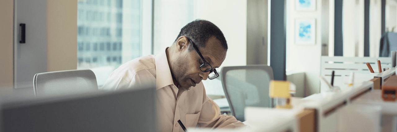 A man writing in the office meeting room