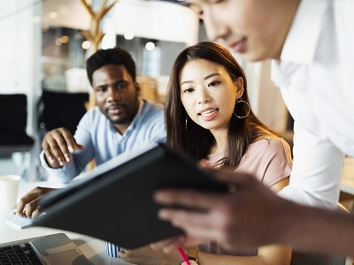 Three young colleagues are working together in the office