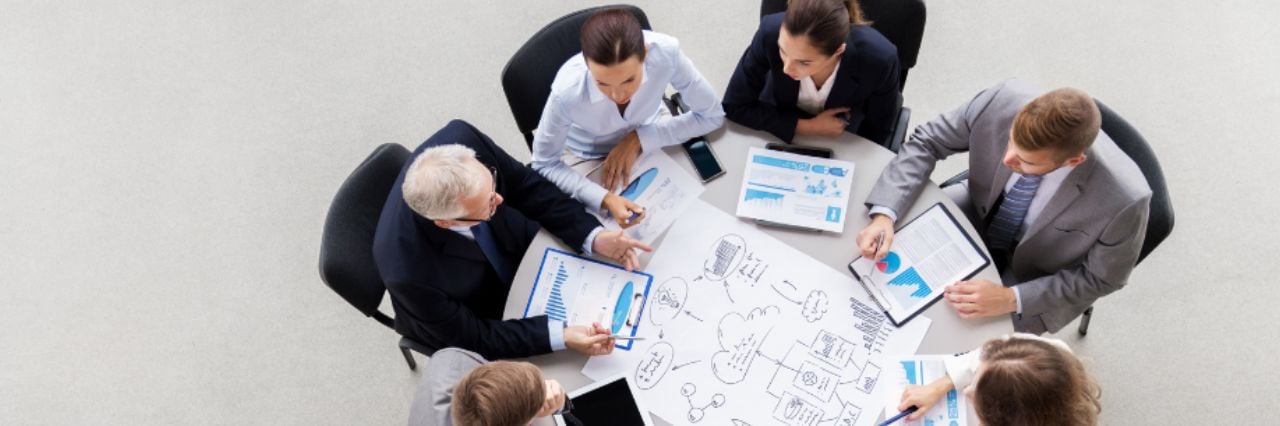 business-team-with-scheme-meeting-and-discussing-problem-at-office