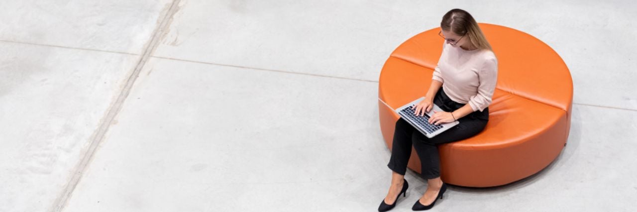 Professional business woman working on her laptop in a modern office