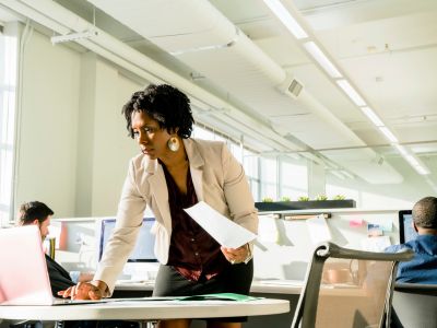 Woman in the office checking documents on her laptop