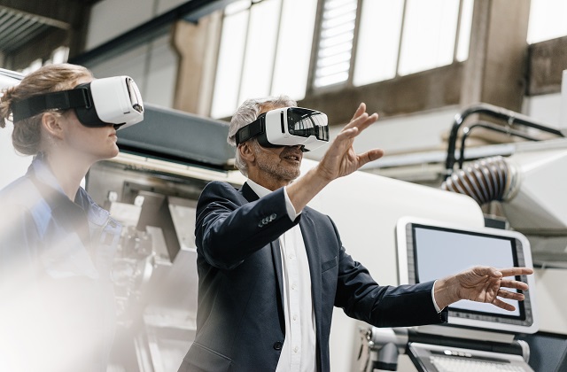 A man and a woman wearing virtual reality headsets