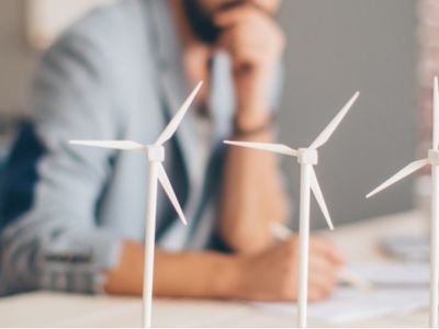 A man studying models of wind turbines