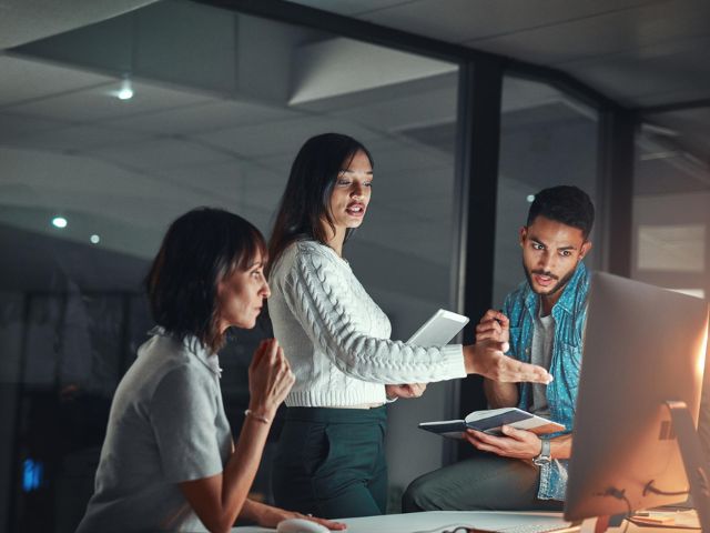 People talking in front of computer