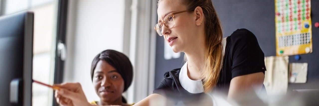 two women working on a computer