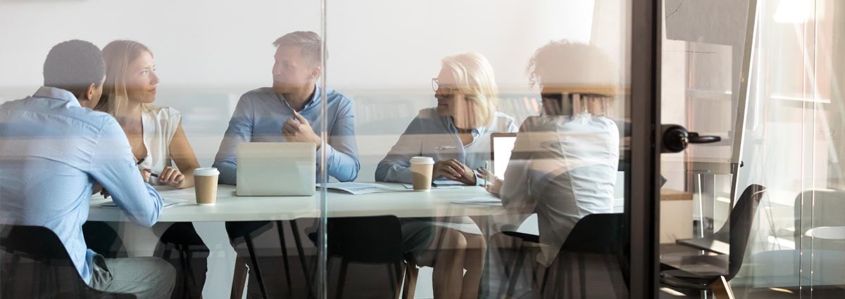 Business people negotiating at boardroom behind closed doors