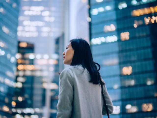 Una manager cammina nel distretto finanziario di una grande città