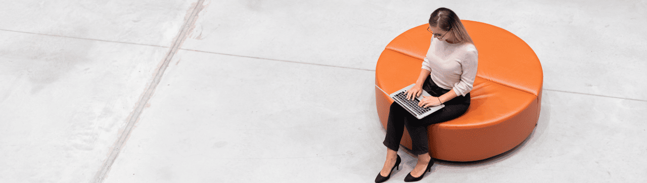 a woman working on a computer on a couch