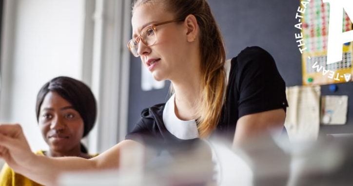 Two-businesswomen-at-an-office-desk-in-a-meeting