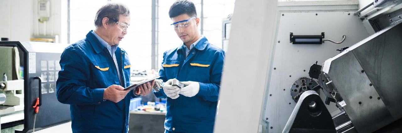 two-men-in-uniforms-in-factory